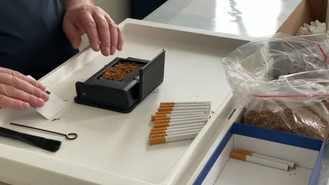 man using manual cigarette rolling machi... | Stock Video