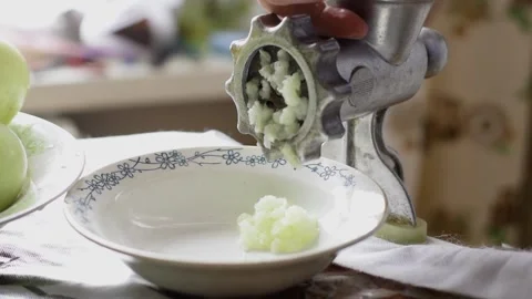 A man using a manual meat grinder in the home kitchen. Stock Footage 152356049