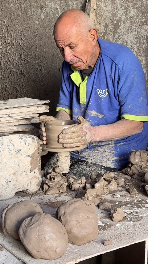 A man using a manual pottery wheel Stock Footage 305899178