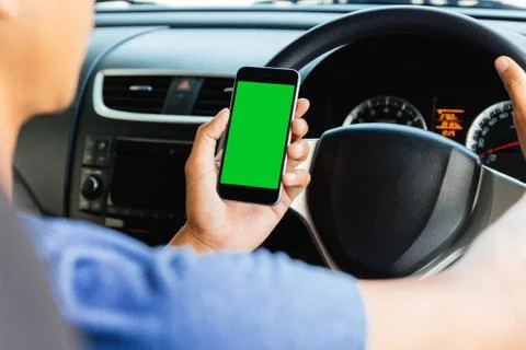 Man using maps app on phone in car, phone green screen easy for adjustment Stock Photos