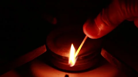Man using a match ignites the gas on a gas stove in the dark 스톡 동영상 49568323