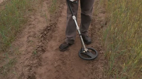 Man using Metal Detector on a Field Road Stock Footage
