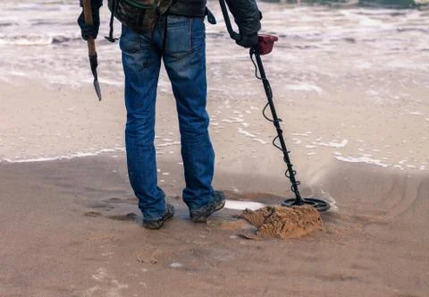 Man using a metal detector to search for metal Stock Photos