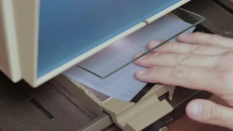 Man using microfiche reader to research archived documents Stock Footage 133294255