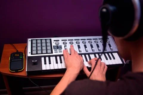 Man is using MIDI keyboard Stock Photos