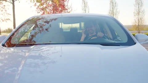 Man using mobile app to unlock rental car in urban environment, showcasing Stock Footage 315528699