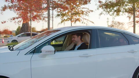 Man using mobile application to unlock rental car in urban setting, showcasing Stock Footage 315531261