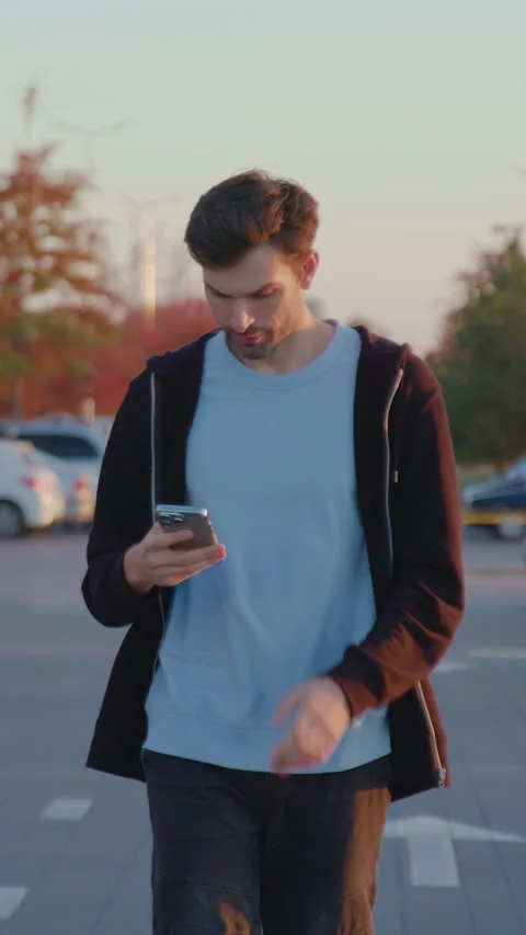 Man using mobile application to unlock rental car in urban parking lot Stock Footage 318473608