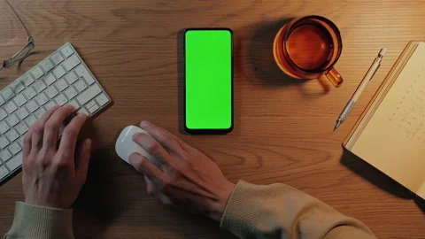 Man using mobile with green screen and keyboard for work Stock Footage 161041799