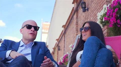 Man is using mobile phone and his girlfriend is drinking juice. Stock Footage 67628866