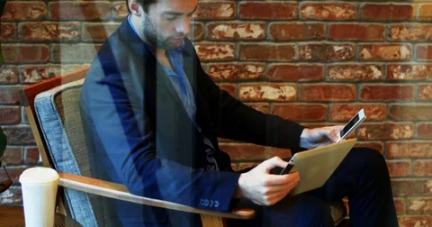 Man using mobile phone and digital table Stock Footage
