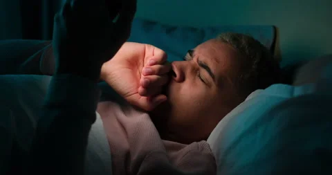 Man using mobile phone and going to sleep on bed Stock Footage 145291617