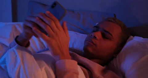 Man using mobile phone and going to sleep Stock Footage 145291862