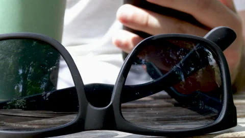Man using mobile phone and drink coffee in public park,wooden table Stock Footage 196822196