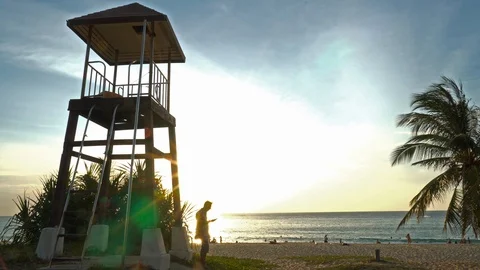 A man using mobile phone on the beach Stock Footage 122549034