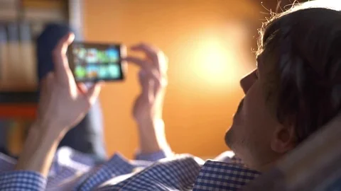 Man using a mobile phone in the bedroom at home Stock Footage 83685117