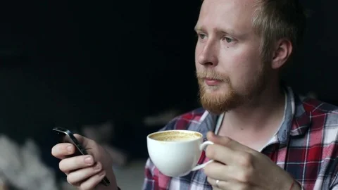 Man Using Mobile Phone in Cafe With Coffe. Video stock 79058552