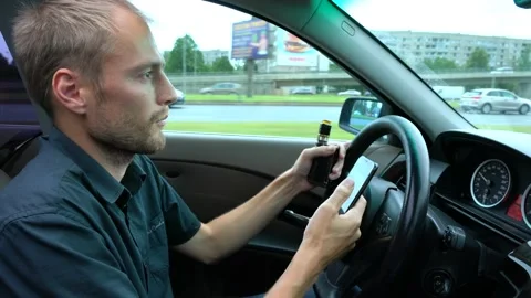 Man using mobile phone at the car. Unsafe drive and texting Stock Footage 144687923