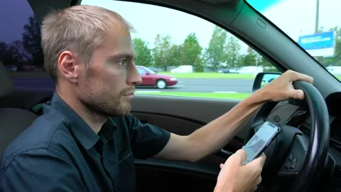 Man using mobile phone at the car. Unsafe drive and texting Stock Footage 144687925