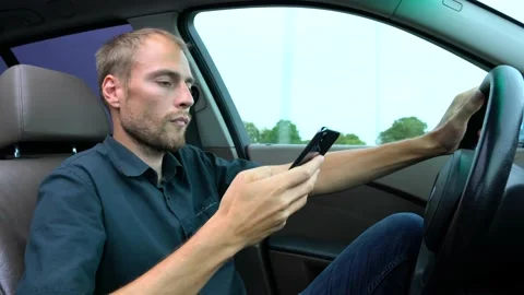 Man using mobile phone at the car. Unsafe drive and texting Stock Footage 144687939