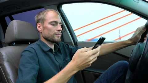 Man using mobile phone at the car. Unsafe drive and texting Stock Footage 144687940