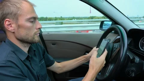 Man using mobile phone at the car. Unsafe drive and texting Stock Footage 144687960
