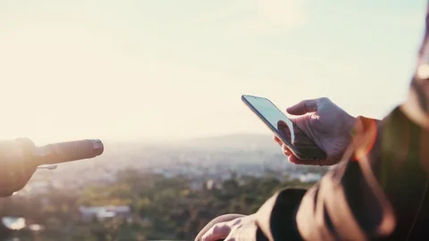 Man using mobile phone check photos he took and scrolling his device to post it Stock Footage 102685338