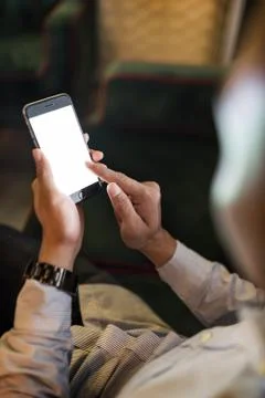 Man using a mobile phone on a couch Stock Photos