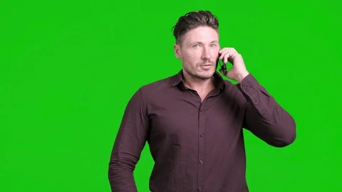 Man using mobile phone on green screen. Talking normally. Stock Footage 105304791