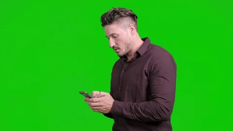 Man using mobile phone on green screen. Surprise win. Video stock 105304891