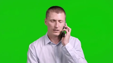 Man using mobile phone on green screen. Talking serious. Stock Footage 105305370