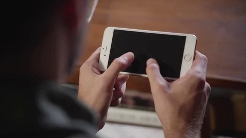Man using mobile phone at home 스톡 동영상 83185070