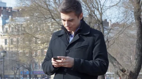 Man using mobile phone outside Stock Footage 61865088