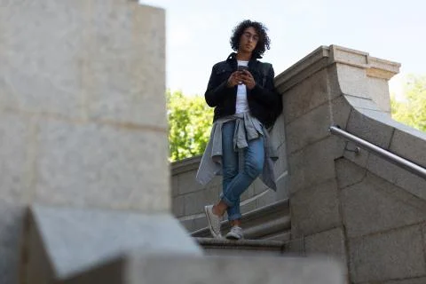 Man using mobile phone outside library building Stockfoto's