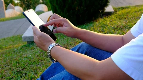 Man using mobile phone at park Stock Footage 81542366