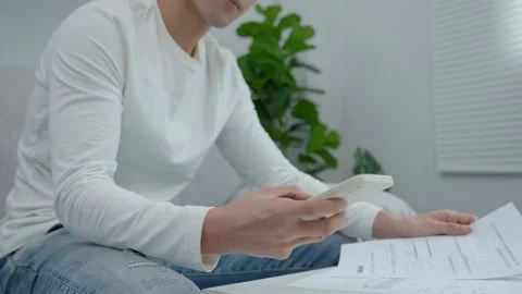 Man using a mobile phone scan QR code for pay bill on monthly. men use techno Stock Footage 217953815