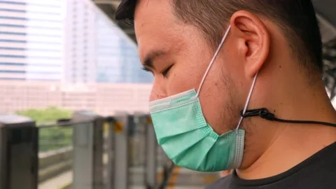 A man using mobile phone waiting for skytrain approaching Stock Footage 142586183