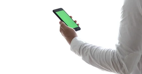 Man using mobile phone while standing near window. Chroma key Stock Footage 90889776