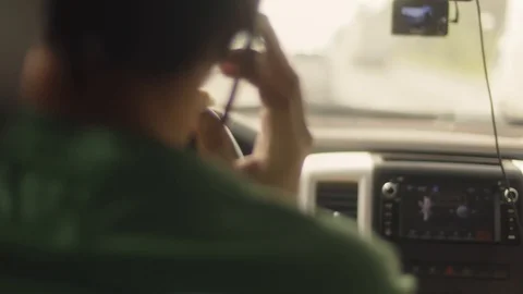 Man using mobile phone while driving a car. Close-up of smartphone in hand Stock Footage 121799198