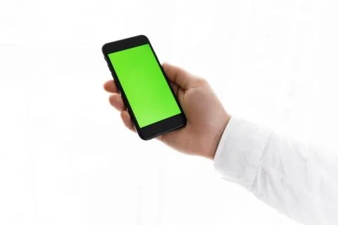 Man using mobile phone while standing near window. Chroma key Stock Photos