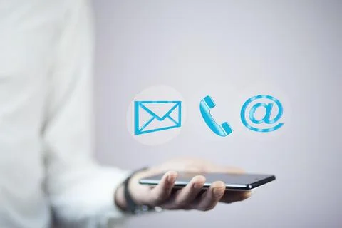 Man using a mobile phone while emitting a clouds of contact icons in a concep Stock Photos