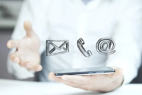 Man using a mobile phone while emitting a clouds of contact icons in a conc.. Stock Photos