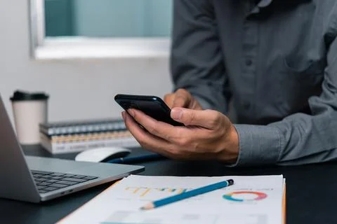 Man using  mobile smartphone working and digital online computer laptop at .. Foto stock