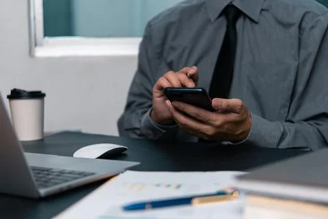 Man using  mobile smartphone working and digital online computer laptop at .. Foto stock