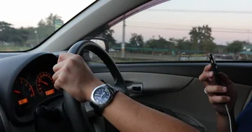 Man using mobile talking speaker phone with driving car Stock Footage 86023348