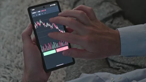 Man Using Mobile Trading App for Online Crypto and Forex Investment Stock Footage 341568885