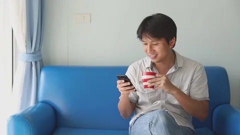 Man using mobile while drinking coffee Video stock 126198694