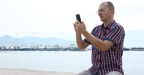 Man Using Mobilephone Touch Screen Messenger in Marina Port Water Transportation Stock-Footage 77041767