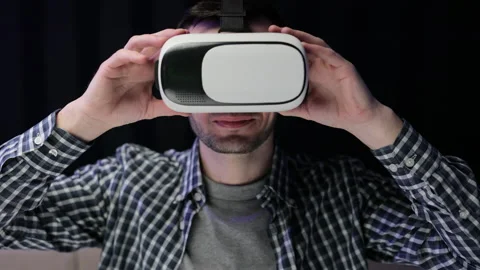 Man using modern 3D vr glasses indoors. Student playing using VR glasses Stock Footage 194552701