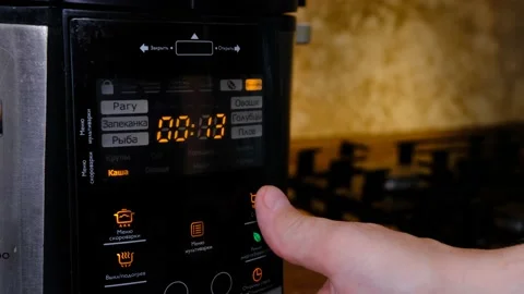 Man using modern multi cooker in kitchen. choosing program Stock Footage 201487717